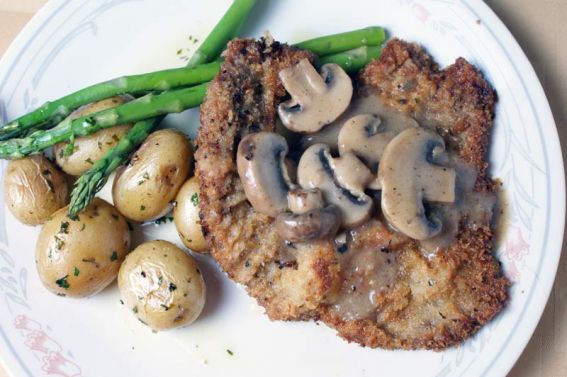 This is a picture of a Jägerschnitzel, which is a schnitzel topped with a mushroom gravy. It's eaten a lot all over Germany, but especially in the southern states.